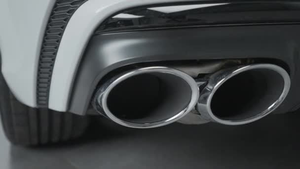 Close-up of exhaust pipes of new car. Action. Double exhaust pipe on new car model with luxury design. New Car parts with Exhaust pipe — Stock Video