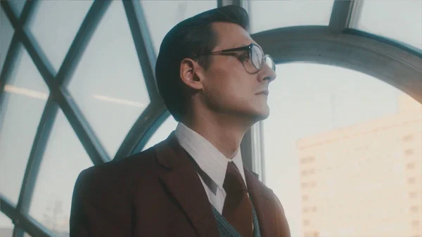 Portrait of a handsome young clever scientist in a classic suit looking pensively through the window and walking away. Stock footage. Academician in a retro scene. — Stock Photo, Image