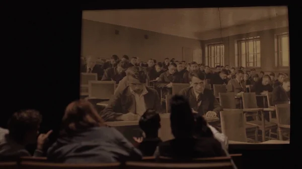 ロシア-モスクワ, 04.14.202:大規模なフィルムスコープ画面上のレトロなソ連の写真を見て暗い講義室での学生の背面ビュー。ストック映像だ。ソ連の人々、機械のショットと歴史セミナー — ストック写真