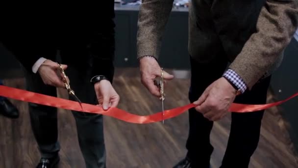 Cutting the ribbon during the special event or the opening, new start and beginning of success. Video. Close up of cutting a red ribbon with golden scissors. — Stock Video