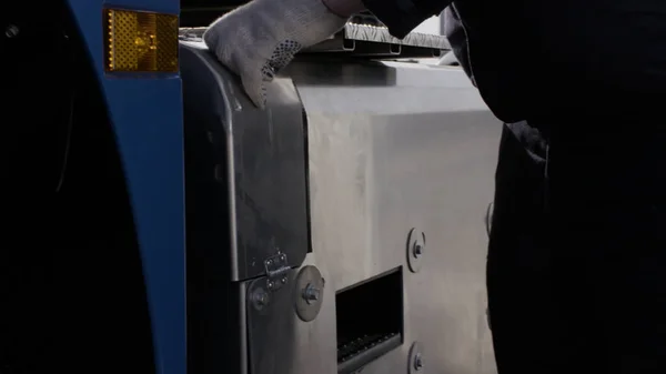 Professional equipment at the car repair center. Scene. Close up of man mechanic hands opening a cover of an inflate compressor. — Stock Photo, Image