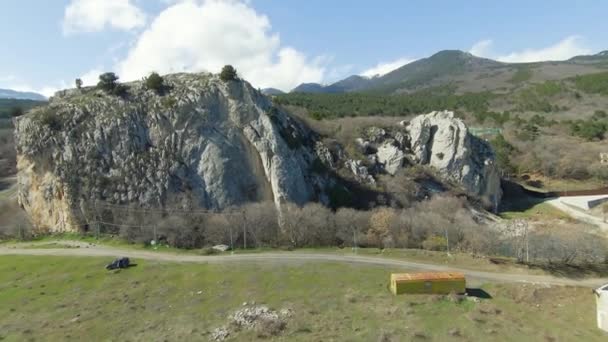 Top view of rocky terrain of mountains. Shot. Fly through beautiful rocky mountain slopes with variety of reliefs. Variety of rocks and erosion reliefs in mountainous terrain — Stock Video