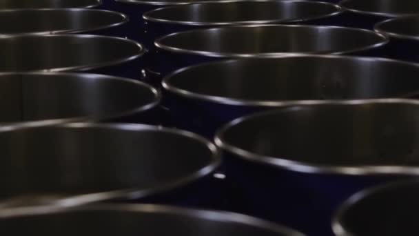 Metal fuel tanks at the storage house. Video. Stack of new metal barrels with with oil or fuel at the warehouse ready for transportation. — Stock Video