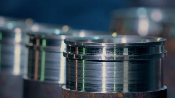 Close up of metal parts of a pipe fitting plant. Video. Metal new shiny bushings at the metallurgical factory.