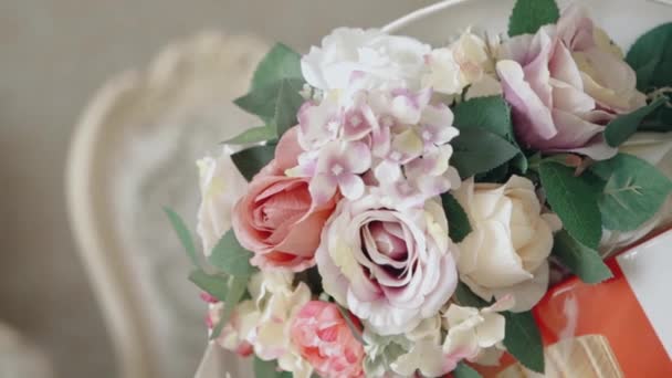 Floral background for a bride on a wedding day. Video. Close up of a soft and beautiful bouquet with opened buds and green leaves. — Stock Video