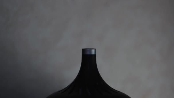 Close up de um umidificador de ar estilizado preto com luzes coloridas isoladas em fundo cinza. Conceito. Detalhes de um interior de casa, vapor branco de umidificador de ar. — Vídeo de Stock