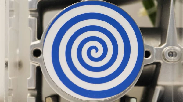 Close-up van roterende witte platte cirkel met heldere blauwe spiraal die hypnotiserend effect creëren. HDR. Ongebruikelijke robot met geautomatiseerde ronddraaiende hypnotische cirkel. — Stockfoto