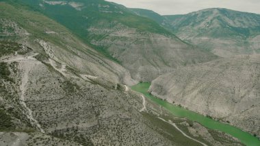 Tehlikeli yolları olan dağ yamaçlarının üst manzarası. Başla. Yeşil dağların yamaçlarında dolambaçlı yollar. Yeşil dağlarda güzel tehlikeli yollar
