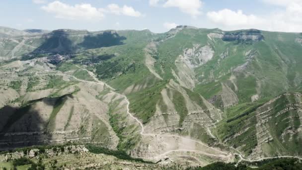 Rocky green mountains on cloudy sky background, aerial view. Action. Mountain range covered by greenery, New Zealand. — Stock Video