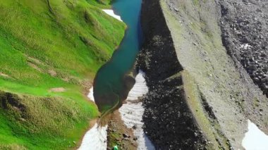 Havadan gelen buzullu sirk gölü dik moraine yamaçları ve durmayan kar yamaçları turkuaz körfez koyları. Medya