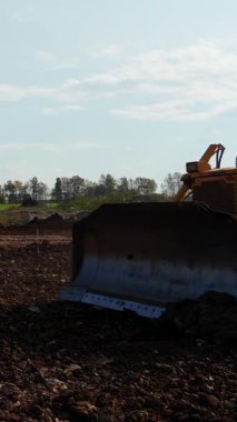 Sarı buldozer seviyeleri inşaat alanında. Kırp