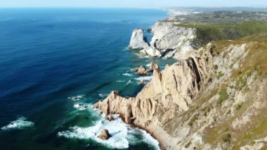 Sivri uçlu kireçtaşı kayalıkların çarpan sörf ve beyaz sprey ile insansız hava aracı tarafından ele geçirilmesi, dramatik kıyı erozyonu. Medya