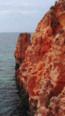 Yeşil sığ suların yanındaki sarp kayalıklar, kapalı hava kayalık çıkıntılar ve berrak deniz havuzları ortaya çıkarır.