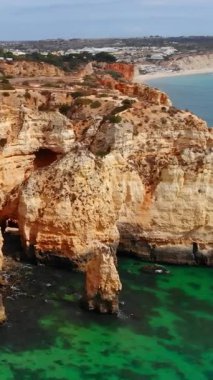 Turkuaz Körfezi ve ahşap kaldırımlı altın tepeler, temiz sığ sular ve kaya kemerleri, sahil şeridi. Medya