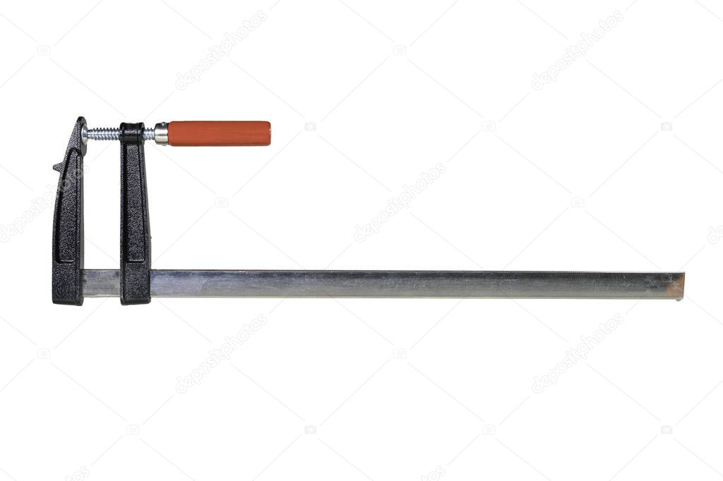 Carpenter's clamp used in a carpentry shop. Metal joinery accessories. Light background.