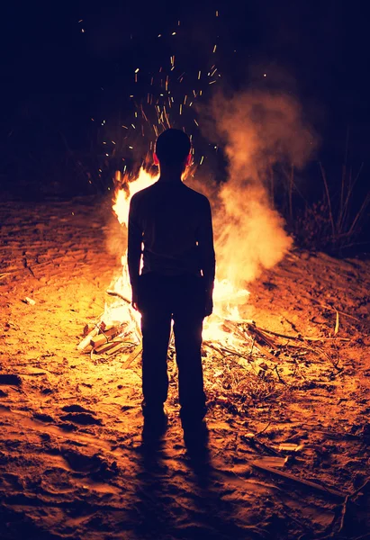 Boy near a bonfire — Stock Photo, Image