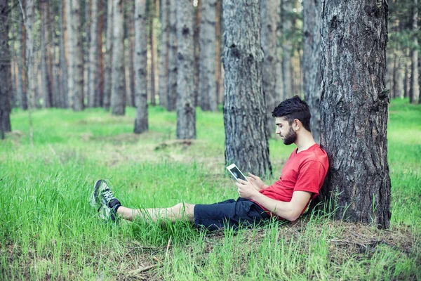 Boy under a tree — Stock Photo, Image