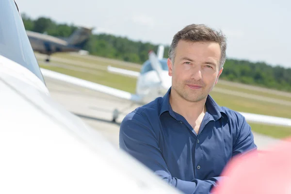 Porträtt av man stod bredvid flygplan — Stockfoto