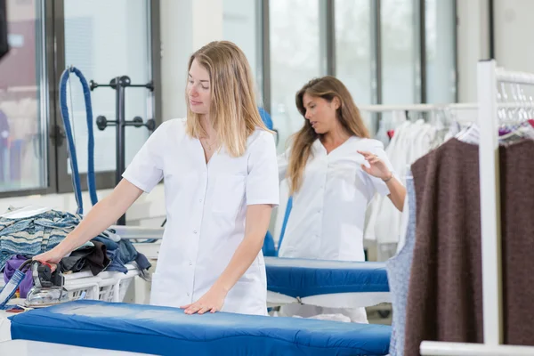 Two ladies working in a dry cleaners