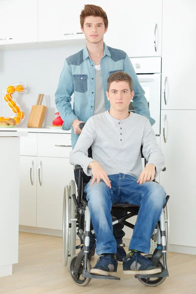 Helping a friend in a wheelchair — Stock Photo, Image