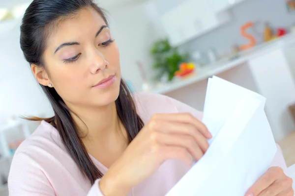 Frau liest zu Hause ein Dokument — Stockfoto