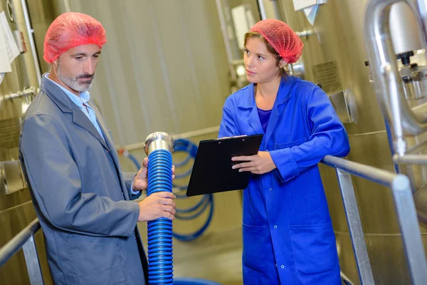 Hombre Sosteniendo Manguera Mujer Sosteniendo Portapapeles — Foto de Stock