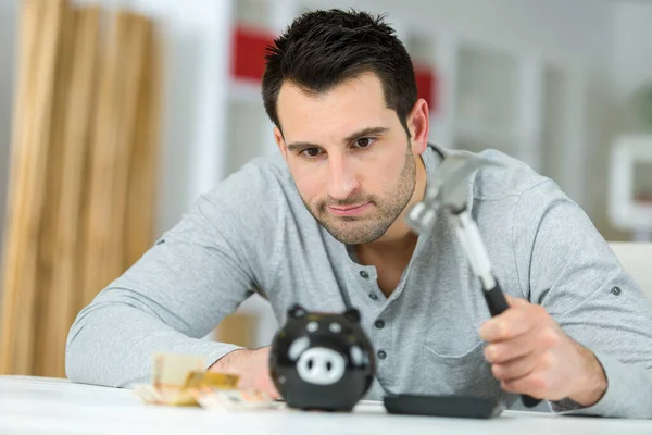 Bedauernder Mann Sparschwein Mit Hammer Zerschlagen — Stockfoto