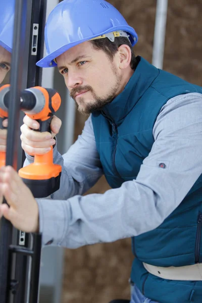 Man Drill Plastic Window — Stock Photo, Image