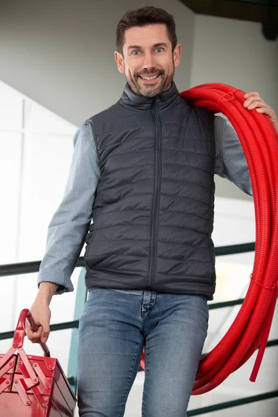 Retrato Sorridente Masculino Trabalhador Segurando Tubo Canteiro Obras — Fotografia de Stock