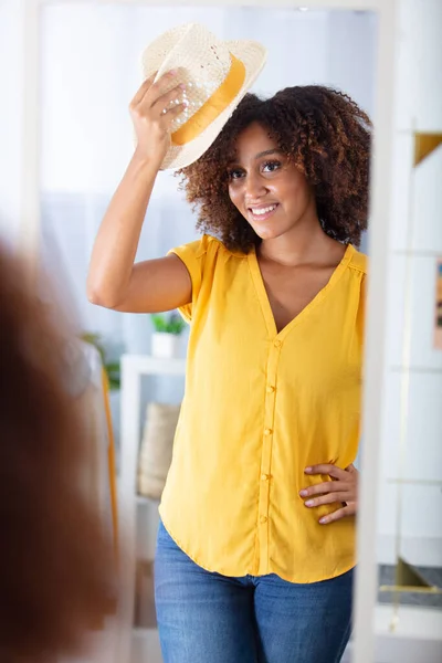 beautiful young woman looking in the mirror