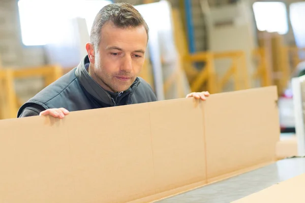 Male Factory Worker Holding Cardboard — Stock Photo, Image
