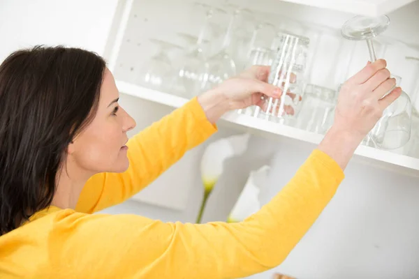 Happy Woman Tidying Wine Glasses — Stock Photo, Image