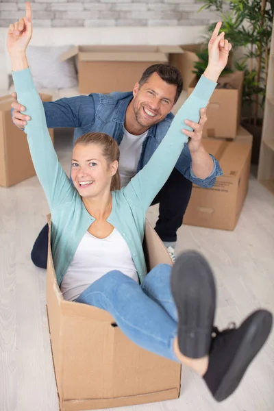 Couple Having Fun Riding Cardboard Boxes — Stock Photo, Image