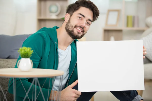 Young Man Living Room Holding Blank Sign — Stock Photo, Image