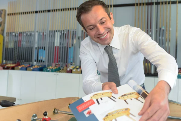 Salesman Showing Table Football Brochure — Stock Photo, Image