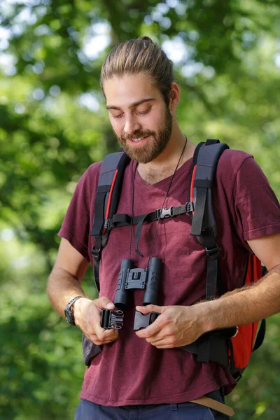 Man Binoculars Fastening His Backpack — Stock Photo, Image