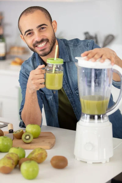 young man cooking fresh vitamin summer juice smoothie