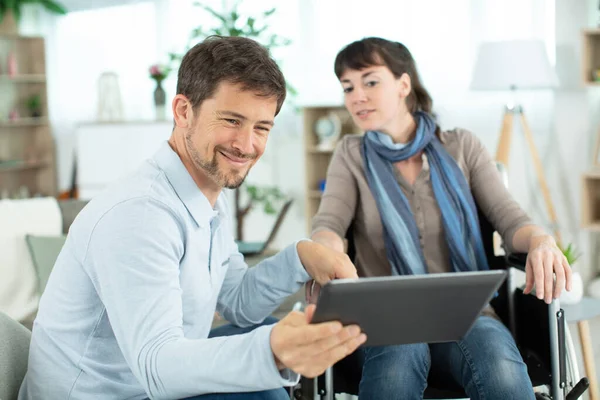 Couple Watching Media Content Tablet Sitting Wheelchair — Stock Photo, Image