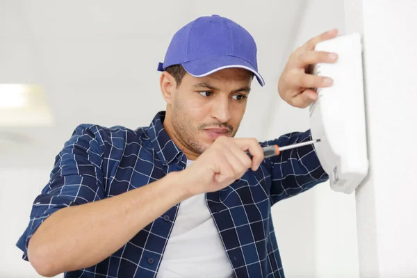 Worker Screwing Alarm Wall — Stock Photo, Image
