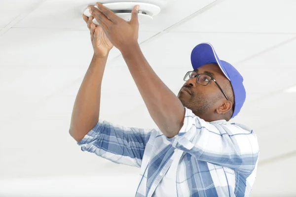 Young Electrician Installing Fire Alarm Unit Wall — Stock Photo, Image