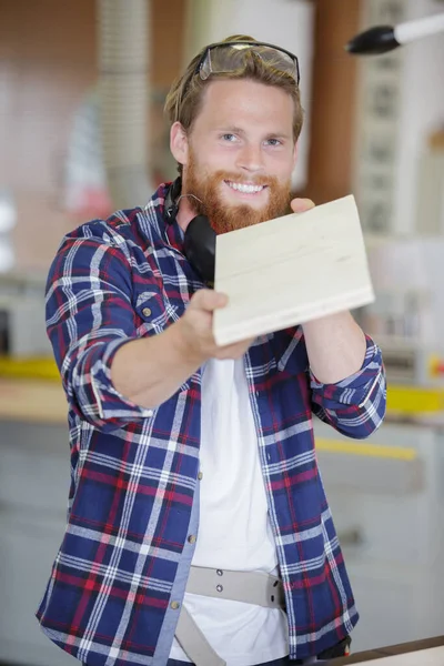 Smiling Worker Showing Wood Camera — Stock Photo, Image