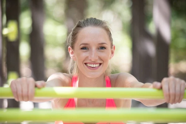 屋外のサルバーの運動器具に立つ女 — ストック写真