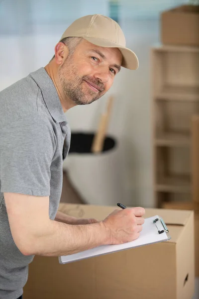 Happy Young Courier Cardboard Box Clipboard — Stock Photo, Image