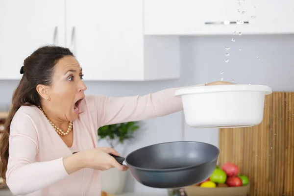 Worried Woman Holding Bucket While Water Droplets Leaking Ceiling — Stock Photo, Image