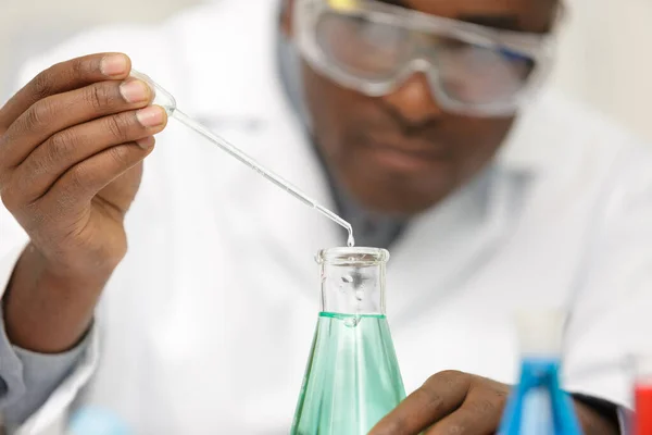 Young Smiling Chemist Googles Holding Purple Liqiud — Stock Photo, Image