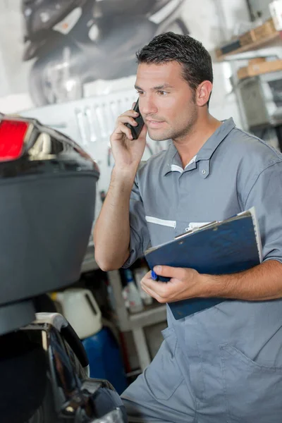 close up of a mechanic on telephone