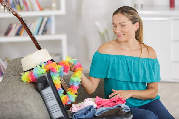 Woman Suitcase Sofa Nostalgically Touching Flower Garland — Stock Photo, Image