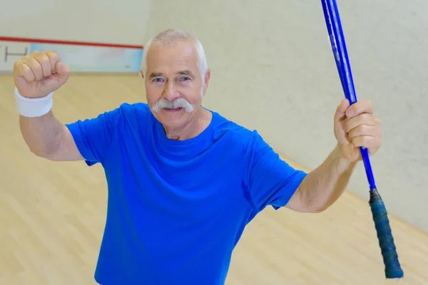 Seniorchef Feiert Sieg Auf Dem Squash Court lizenzfreie Stockfotos