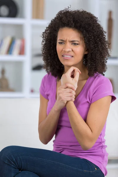 Woman Home Holding Wrist — Stock Photo, Image