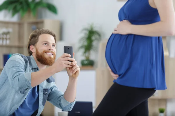 男人给孕妇拍照 — 图库照片